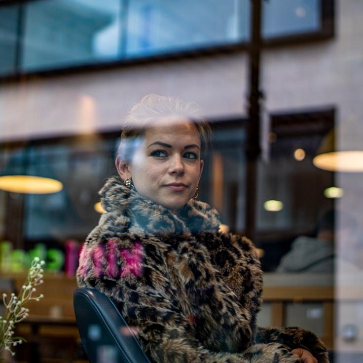 Avery Chen, Lead Design Curator at MarshIrisFlint, reviewing corporate floral arrangements